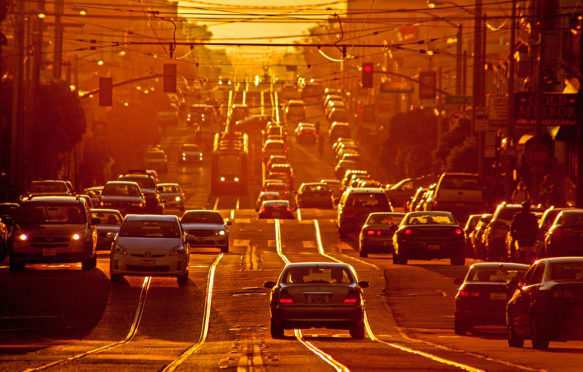 Setting sun shines on afternoon traffic on Taraval Street in San Francisco. Credit: MarmadukeSt. John / Alamy Stock Photo. DR8AK8