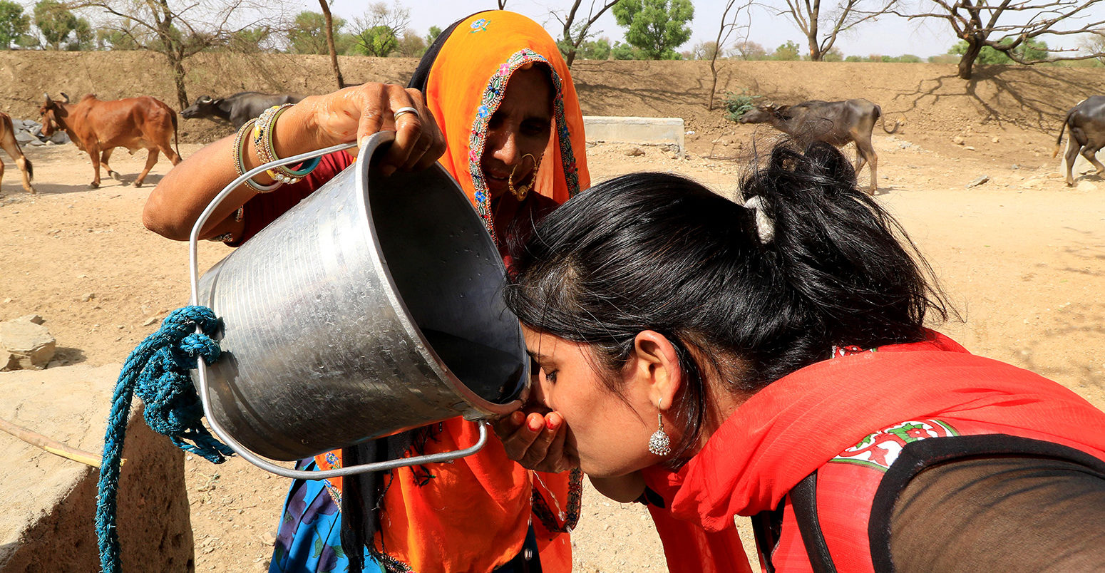 A woman quenches her thirst in Jaipur, India, during a severe heatwave in May 2016. Credit: PACIFIC PRESS / Alamy Stock Photo. G1TTR7