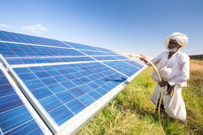 Cleaning solar panels in Gujarat Solar Park, Gujarat, India. Credit: Ashley Cooper pics / Alamy Stock Photo. DRARW5