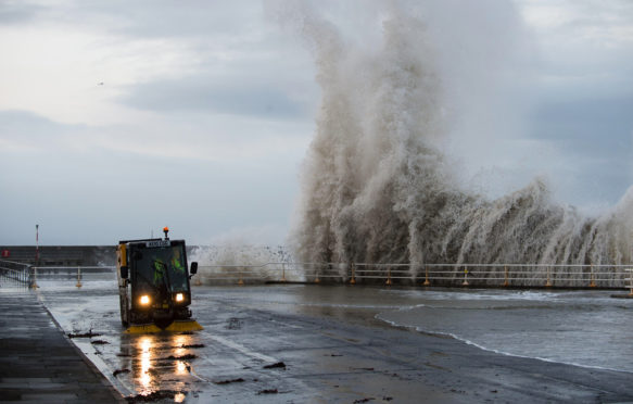 DN1ENH Aberystwyth Wales UK, Wednesday 18 December 2013. At the peak of the tide, gale force winds bring massive waves crashing onto the seafront at Aberystwyth on the west Wales coast. Winds are expected to increase in severity throughout the day, peaking at 50-60mph by the late afternoon. A yellow weather warning is in place for large parts of Wales today with the Met Office warning of high winds and heavy rain that could cause localised flooding. Gusts of up to 70mph are expected in exposed coastal areas. Photo Credit: keith morris/Alamy Live News