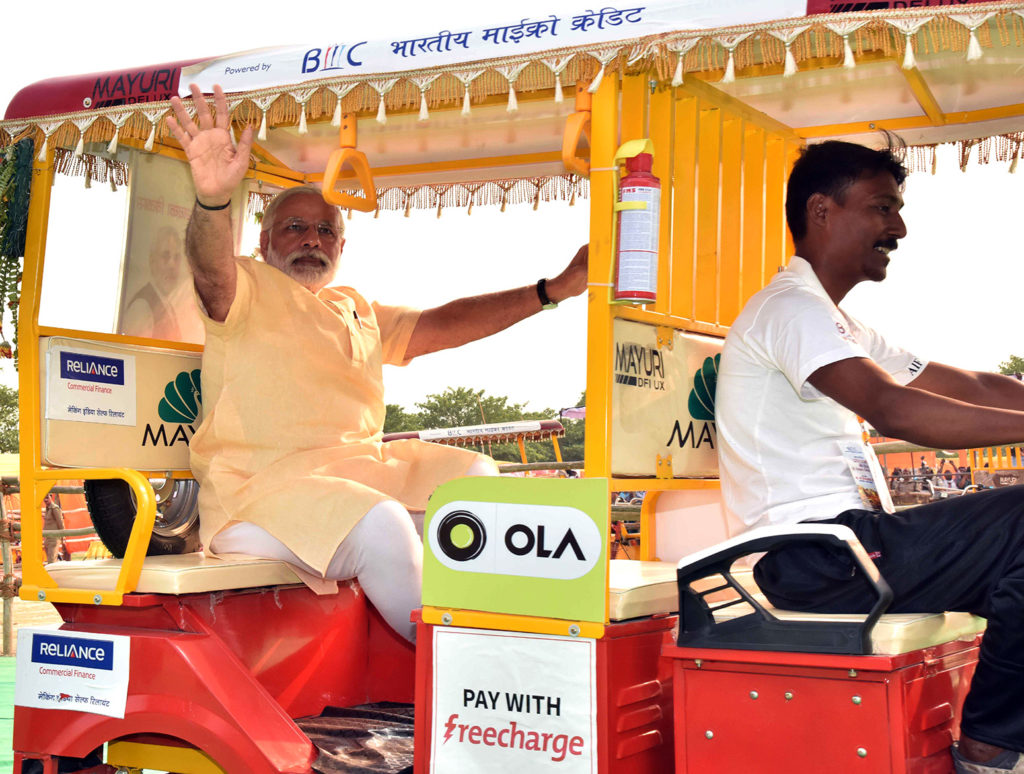 Indian Prime Minister Narendra Modi rides an all-electric motorised rickshaw after distributing 1000 of the vehicles to constituents. Varanasi, India, 1 May, 2016. G0K24P