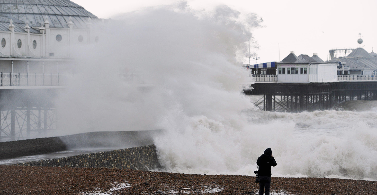 FEMFKX Brighton, UK. 8th February, 2016. UK Weather: Huge waves break over Brighton seafront at high tide by the pier as Storm Imogen batters the south coast today with the weather forecast predicting wind speeds of up to 90 mph causing widespread flooding and damage Credit: Simon Dack/Alamy Live News