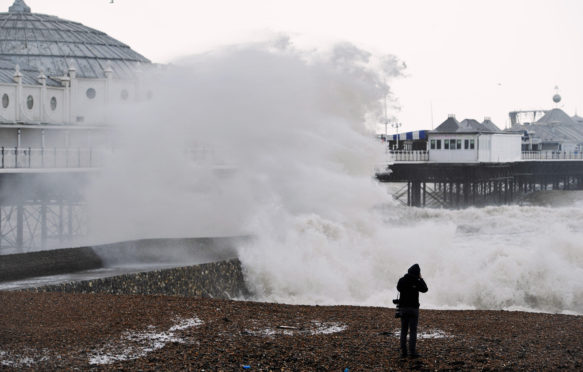 FEMFKX Brighton, UK. 8th February, 2016. UK Weather: Huge waves break over Brighton seafront at high tide by the pier as Storm Imogen batters the south coast today with the weather forecast predicting wind speeds of up to 90 mph causing widespread flooding and damage Credit: Simon Dack/Alamy Live News