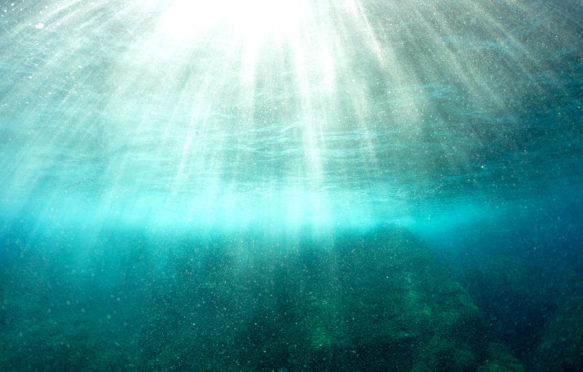 Sunrays penetrating water's surface, Port-Cros island, France. Credit: Sami Sarkis / Alamy Stock Photo.CE9ENH
