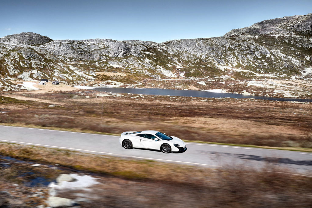 A Mclaren 650s driving in Rjukan, Norway. Credit: Artur Nyk / Alamy Stock Photo. JCGXRD