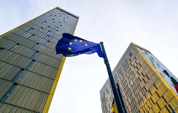 EP6P4C Golden twin towers of the Court of Justice of the European Union, in European Quarter, Kirchberg, Luxembourg, behind the EU flag