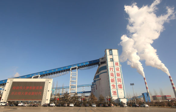 Smoke billows from a coal plant and industrial facility in Datong, China. Credit: Newscom / Alamy Stock Photo. R86028