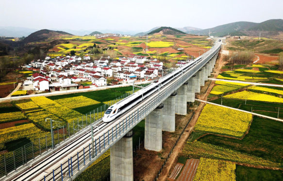 A bullet train runs on the Xi'an-Chengdu high-speed railway line in Shaanxi Province, China. Credit: Xinhua / Alamy Stock Photo. PC6B12