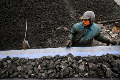 Miners prepare coal for transport at a coal mine site in Changzhi, China. Credit: CPRESS PHOTO LIMITED / Alamy Stock Photo. EX2865