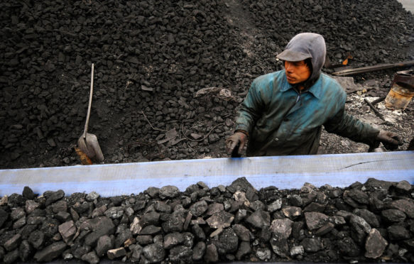 Miners prepare coal for transport at a coal mine site in Changzhi, China. Credit: CPRESS PHOTO LIMITED / Alamy Stock Photo. EX2865