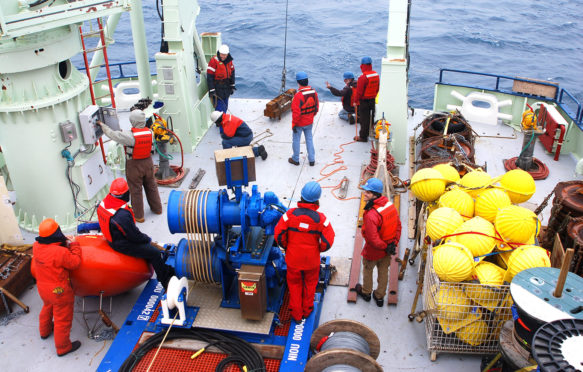 The deployment of the first OSNAP science mooring, named 'IC0', which measured water column properties on the western flank of the Reykjanes Ridge as part of the OSNAP array. July 2014. Credit: Credit: Heather Furey, Woods Hole Oceanographic Institution