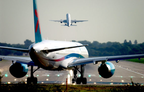 A plane prepares for takeoff from London Gatwick airport at dawn. Credit: Roger Bamber / Alamy Stock Photo. AM1G59