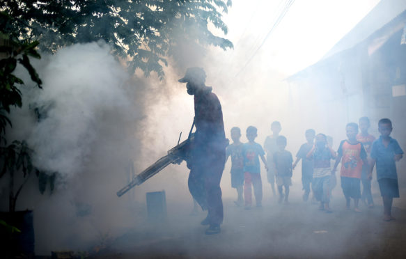 Mosquito fogging to prevent against Dengue fever in Jakarta, Indonesia, 30 March 2015. Credit: Reynold Sumayku / Alamy Stock Photo. EJNEYB