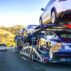 A car transporter carries new Tesla Model 3 vehicles along the highway, California, US. Credit: Andrei Stanescu / Alamy Stock Photo. R6HR26
