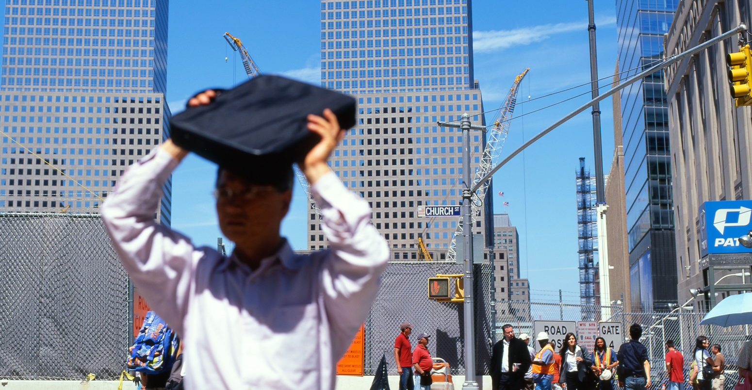 A man shades his face from the summer heat, New York. Credit: Kathy deWitt / Alamy Stock Photo.