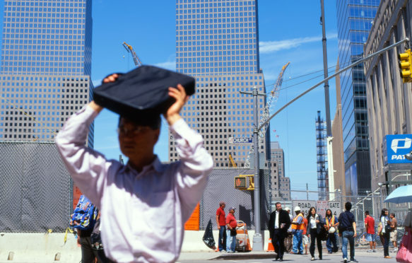 A man shades his face from the summer heat, New York. Credit: Kathy deWitt / Alamy Stock Photo.
