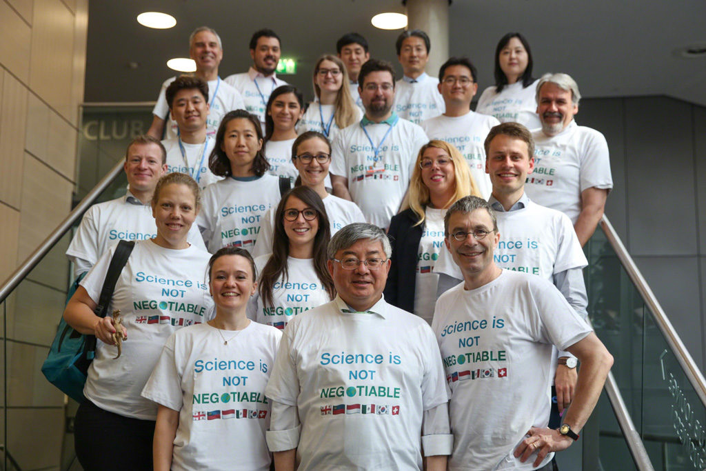 Members of the Environmental Integrity Group arrived at the closing plenary in T-shirts saying “science is not negotiable”. Photo by <a target="_blank" href="http://enb.iisd.org/climate/sb50/images/27jun/ENB_SB50_27June19_KiaraWorth-19.jpg">IISD/ENB | Kiara Worth</a>