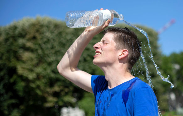 A man cools himself in Lille, France, 28 June 2019, as temperatures in France hit 45C. Credit: Xinhua / Alamy Stock Photo.