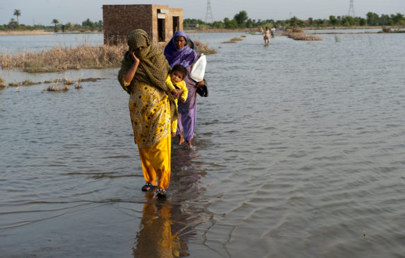 National Flood Emergency Response in Pakistan. A family crosses the flooded streets of Pakistan.