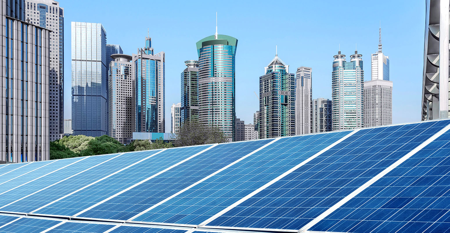 Solar panels in front of Shanghai skyline. Credit: Yong nian Gui / Alamy Stock Photo. HT79MD