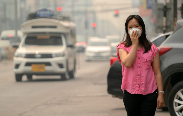A woman wears a protective mask in Chiang Mai, Thailand. Credit: Anan Kaewkhammul / Alamy Stock Photo. T19P7D
