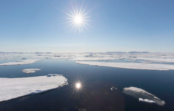 Midnight sun over the Arctic Ocean, Svalbard, Norway. Credit: Arterra Picture Library / Alamy Stock Photo.