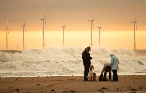 Offshore windfarm near Seaton Carew beach, County Durham, UK. Credit: Islandstock / Alamy Stock Photo. PYWFWF