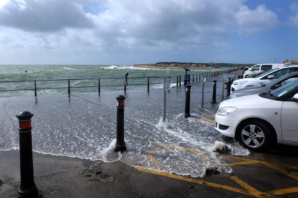 Coastal flooding into car park and walkway, Mudeford quay, Dorset, UK. Credit: Helen James / Alamy Stock Photo