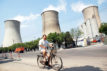 A cyclist rides past a coal-fired power plant in Beijing, China. Credit: Imaginechina Limited / Alamy Stock Photo. W9CEBT