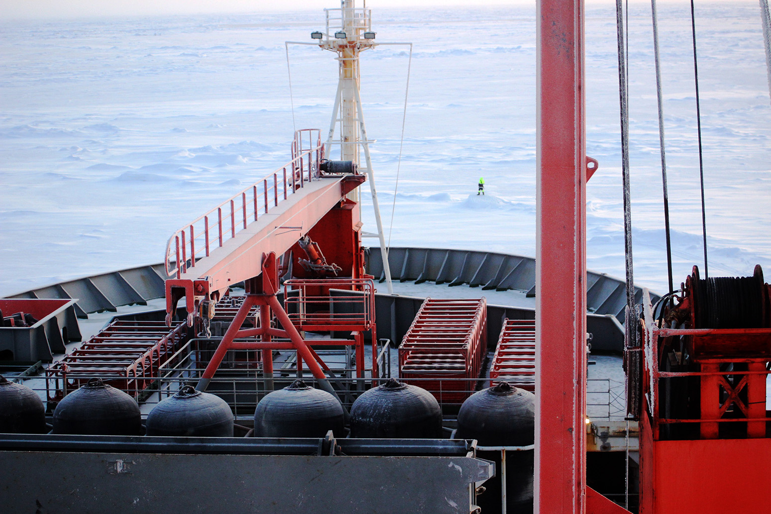 A polar-bear guard watches the horizon in front of the bow of the Akademik Fedorov. 