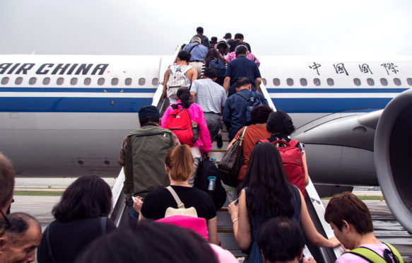 Passengers boarding an Air China plane at the Beijing Airport. Credit: Edwin Remsberg / Alamy Stock Photo.