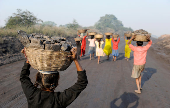 Coal remains are collected to be sold at a local market, Jharkhand, India. Credit: Joerg Boethling / Alamy Stock Photo. HN5KMY