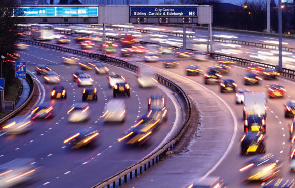 Early morning traffic on the M8 Motorway in Glasgow, Scotland. Credit: Kenny Williamson / Alamy Stock Photo