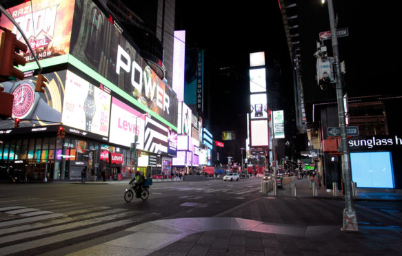 A largely empty Times Square during the Coronavirus pandemic, New York City. 21 March 2020. Credit: Adam Stoltman / Alamy Stock Photo