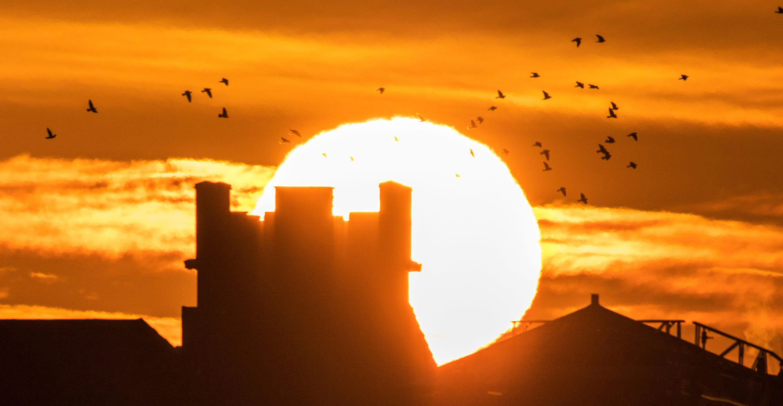 Unseasonably warm weather as the morning sun rises over the historic landmarks along the promenade in Southport on Merseyside, UK. 2 January 2020. Credit: KeyWorded / Alamy Stock Photo