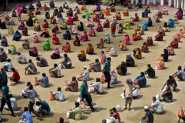 Bangladeshi homeless people wait in a queue for aid during the nationwide coronavirus lockdown. Dhaka, Bangladesh, 4 April 2020. Credit: SK Hasan Ali / Alamy Stock Photo