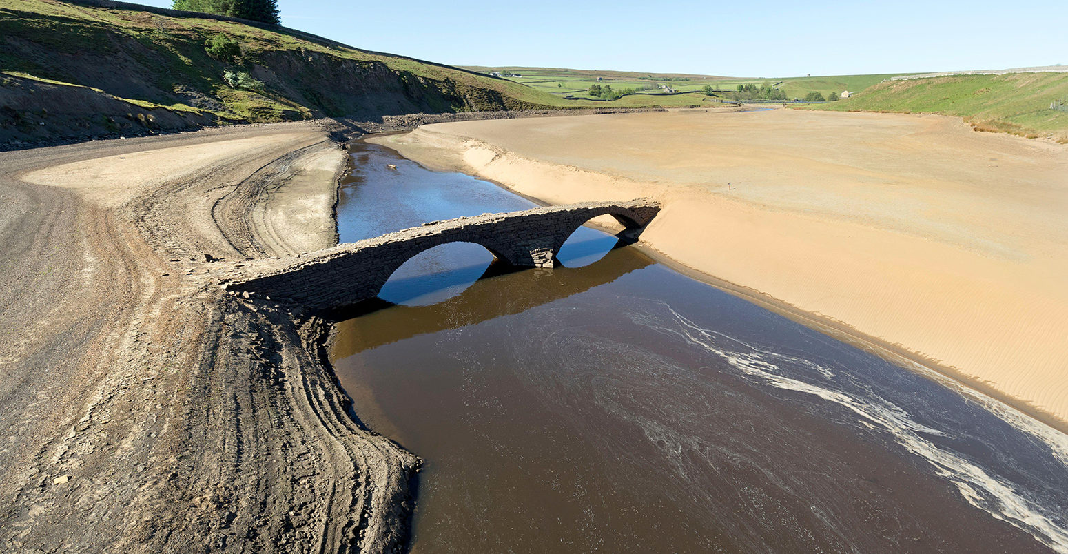 An old packhorse bridge normally submerged in Grassholme Reservoir, County Durham, UK, is revealed after dry weather conditions, on 1 June 2020. Credit: David Forster / Alamy Stock Photo. 2BWEP9A