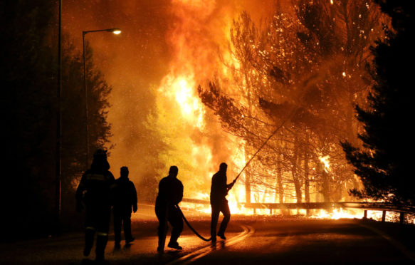 Firemen battle with the flames in Kalamos 2017.