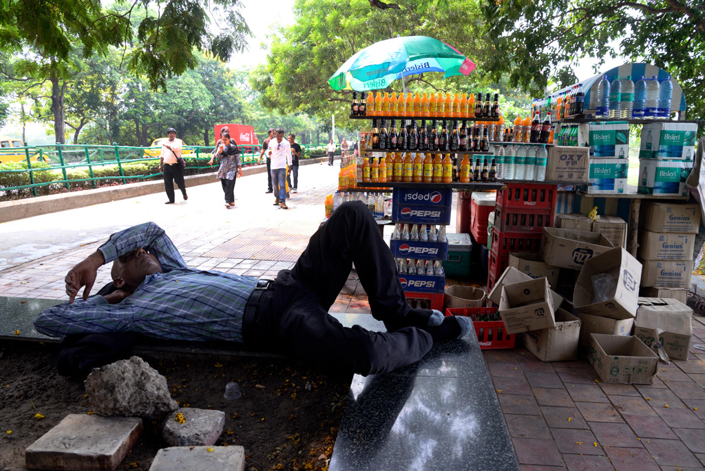 Local people of Kolkata taking resting under the tree in afternoon, as heat wave continues in Kolkata and other parts of India, 2015.