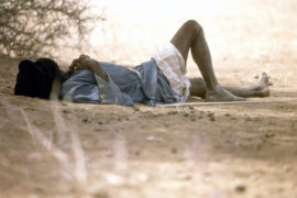 Mauritanian man shelting from the heat.