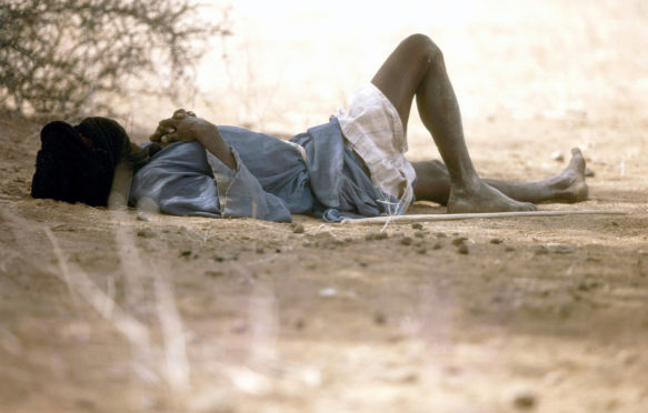 Mauritanian man shelting from the heat.
