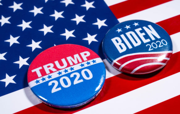 Donald Trump and Joe Biden pin badges, pictured of the USA flag.