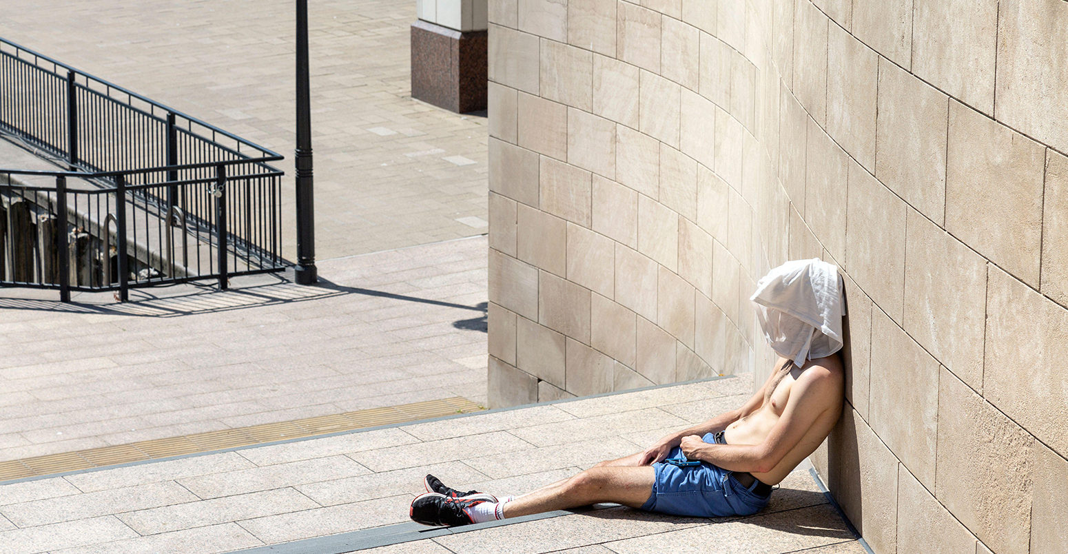 Man with a t-shirt over his head during August 2020 heatwave