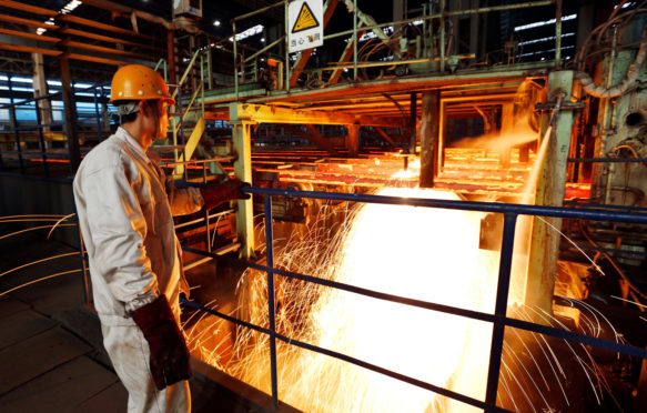 A-chinese-worker-surveys-the-production-of-steel-at-a-steel-plant-in-Lianyungang-east-Chinas-Jiangsu-province