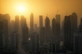 Dubai Marina skyscrapers at sunset with heat haze. May 2017. Andrew Deer / Alamy Stock Photo