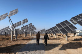 Workers walk at a solar power station in Tongchuan, Shaanxi province, China December 11, 2019. Picture taken December 11, 2019. Credit: REUTERS/Sean Yong