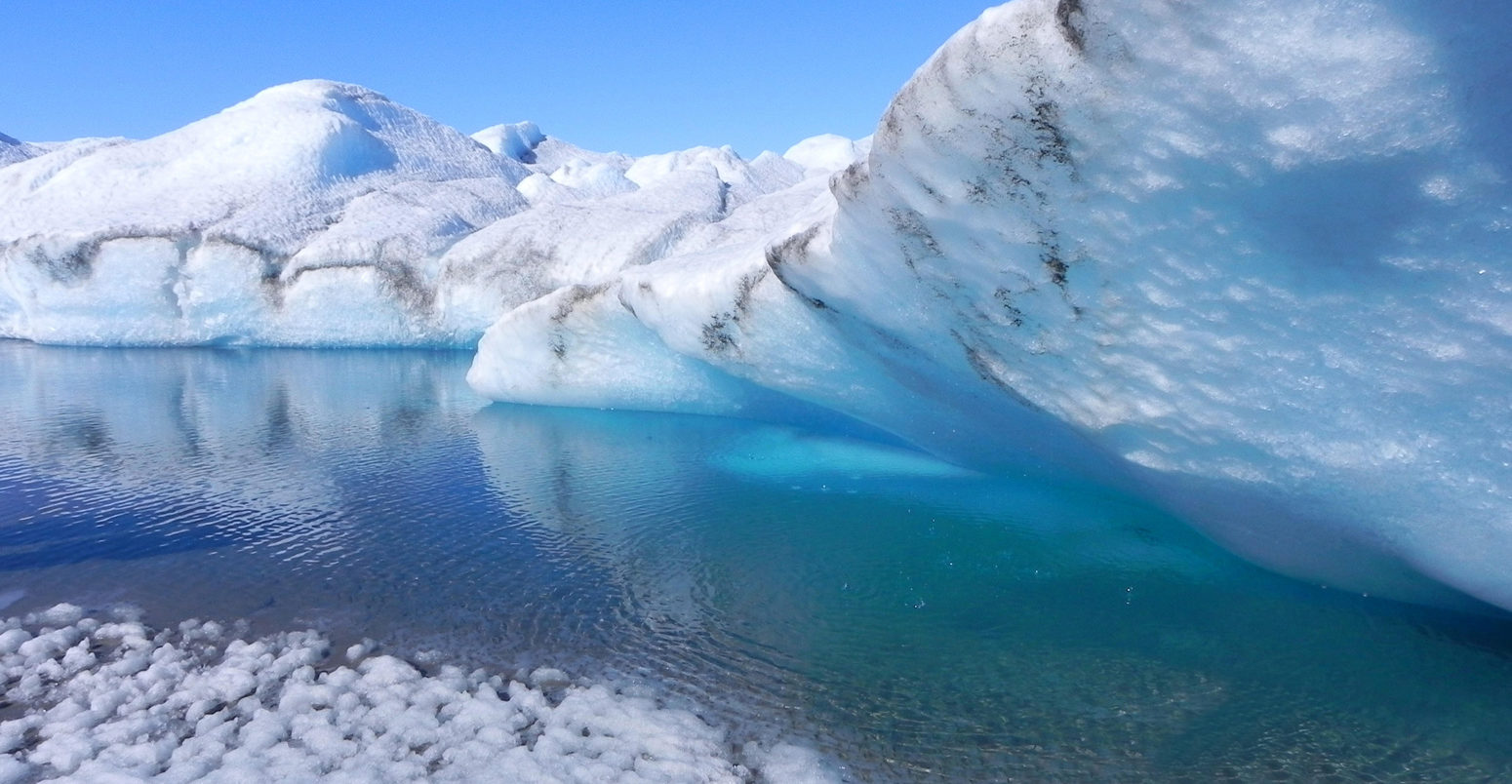 Melting ice in Greenland - ice cave with blue water on inland ice sheet.