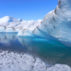 Melting ice in Greenland - ice cave with blue water on inland ice sheet.