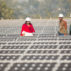 Workers-at-a-1MW-solar-power-station-run-by-Tata-Power-on-the-roof-of-an-electricity-company-in-Delhi,-India