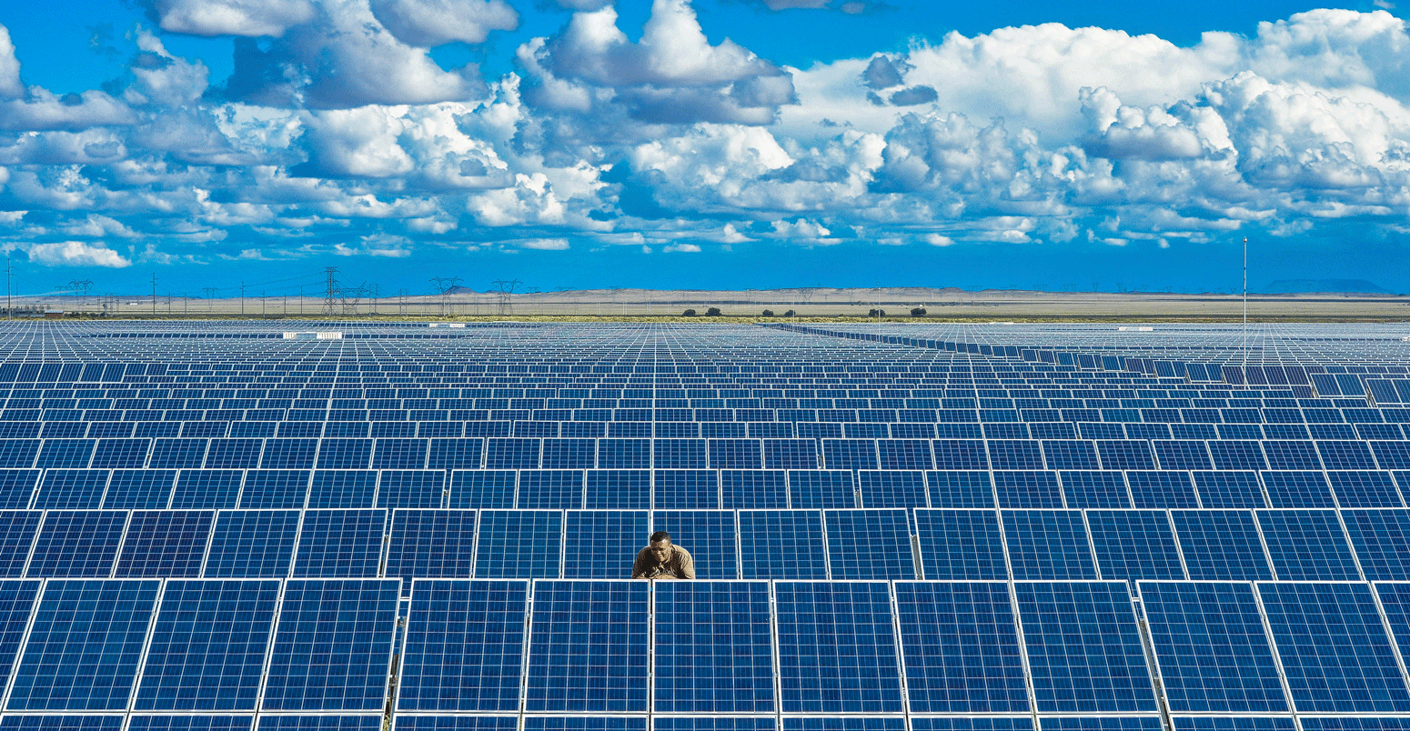 A man checks panels on a solar farm in South Africa